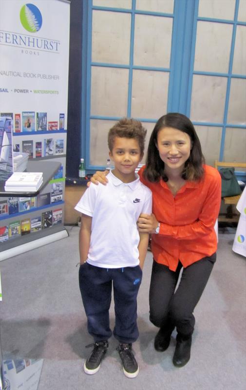 Xu Lijia with a young sailing fan on the Fernhurst Books stand at the RYA Suzuki Dinghy Show photo copyright Rachel Atkins taken at RYA Dinghy Show and featuring the  class