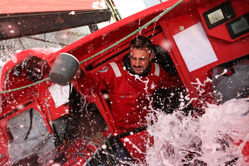 Wet conditions onboard for Eric Peron as he even uses it to his advantage to wash the dishes on leg 2 of the Volvo Ocean Race photo copyright Yann Riou / Volvo Ocean Race taken at  and featuring the Volvo One-Design class